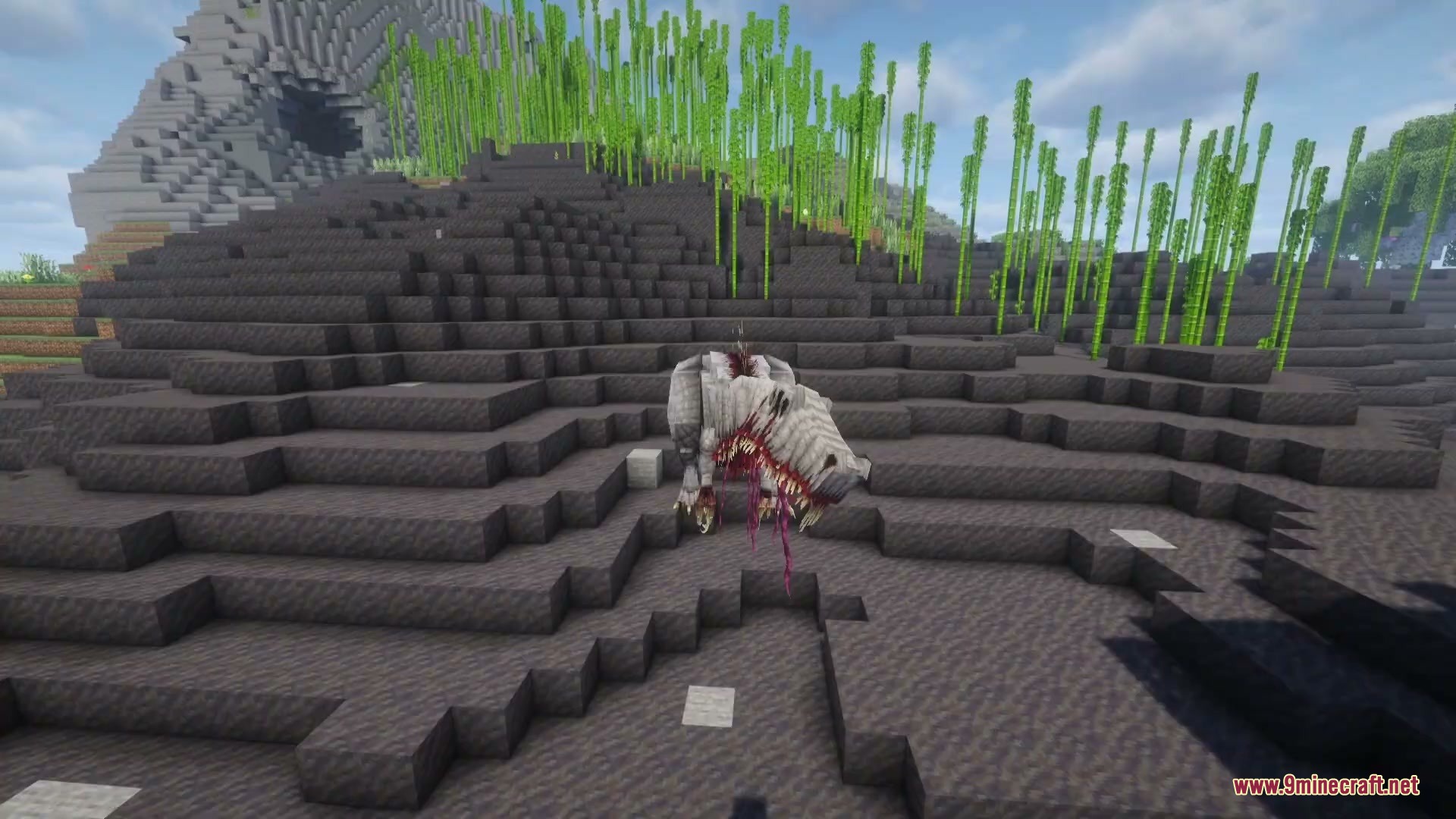 The parasitic prehistoric beast stands on a dark rocky hill near bamboo
