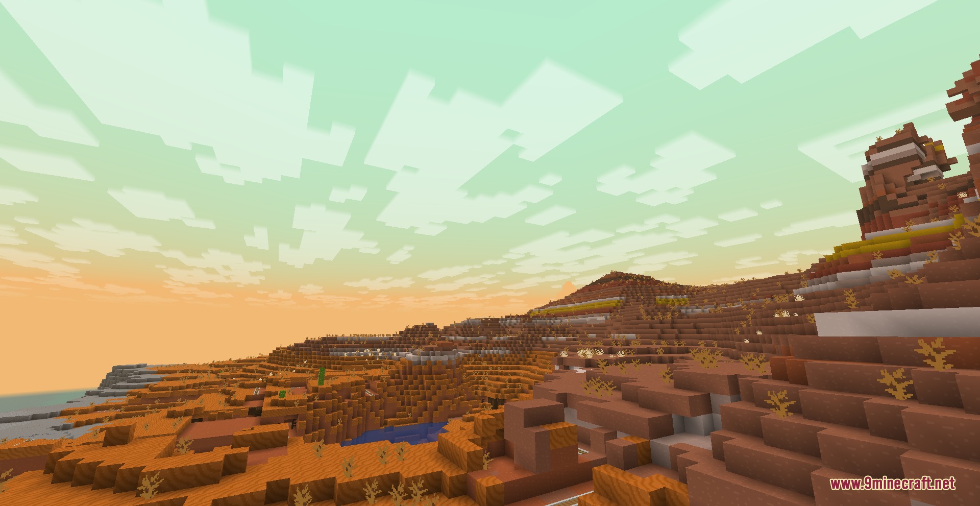 Prismatic Atmosphere Resource Pack Screenshot 2 Vast badlands landscape with orange hills under a warm hazy green sky