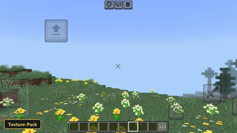 Grassy hillside with yellow and white flowers, small 'X' crosshair