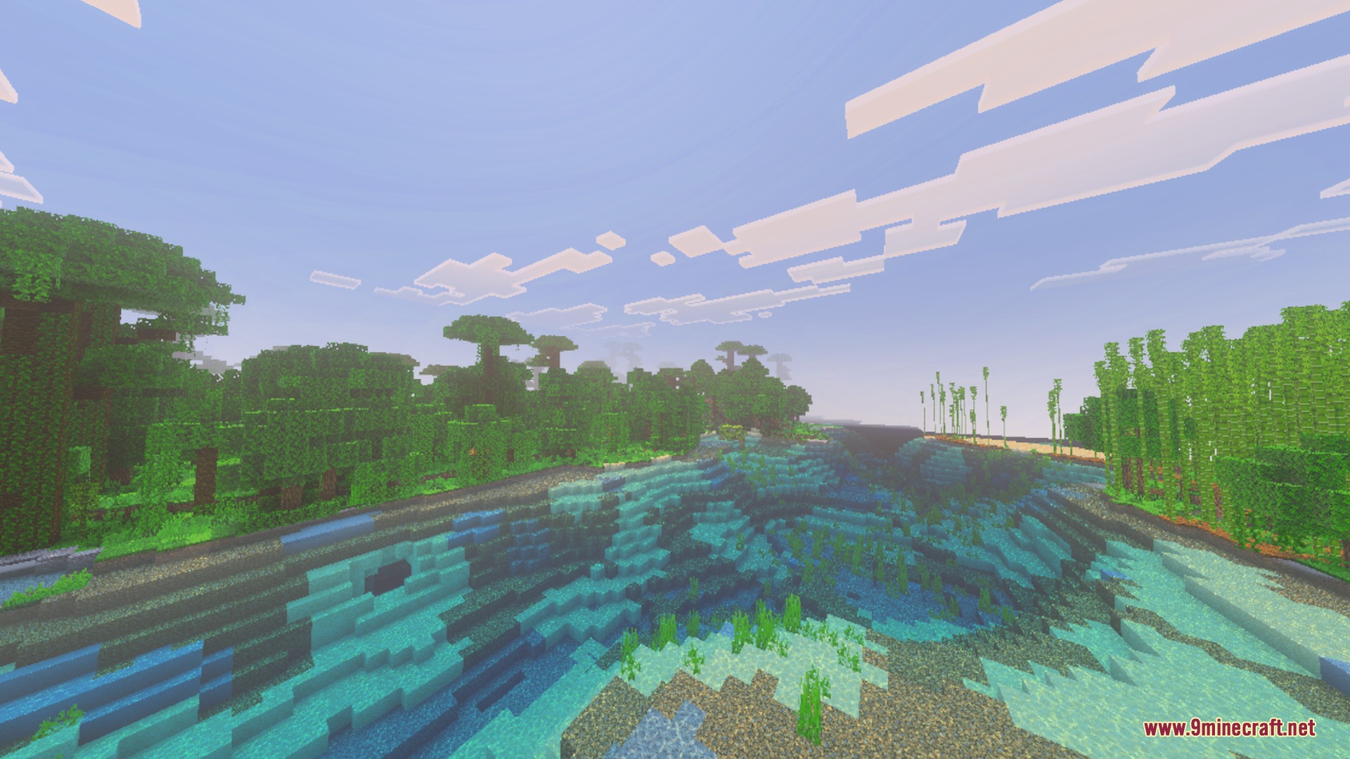 A lush jungle and bamboo forest bordering a clear blue river in Minecraft