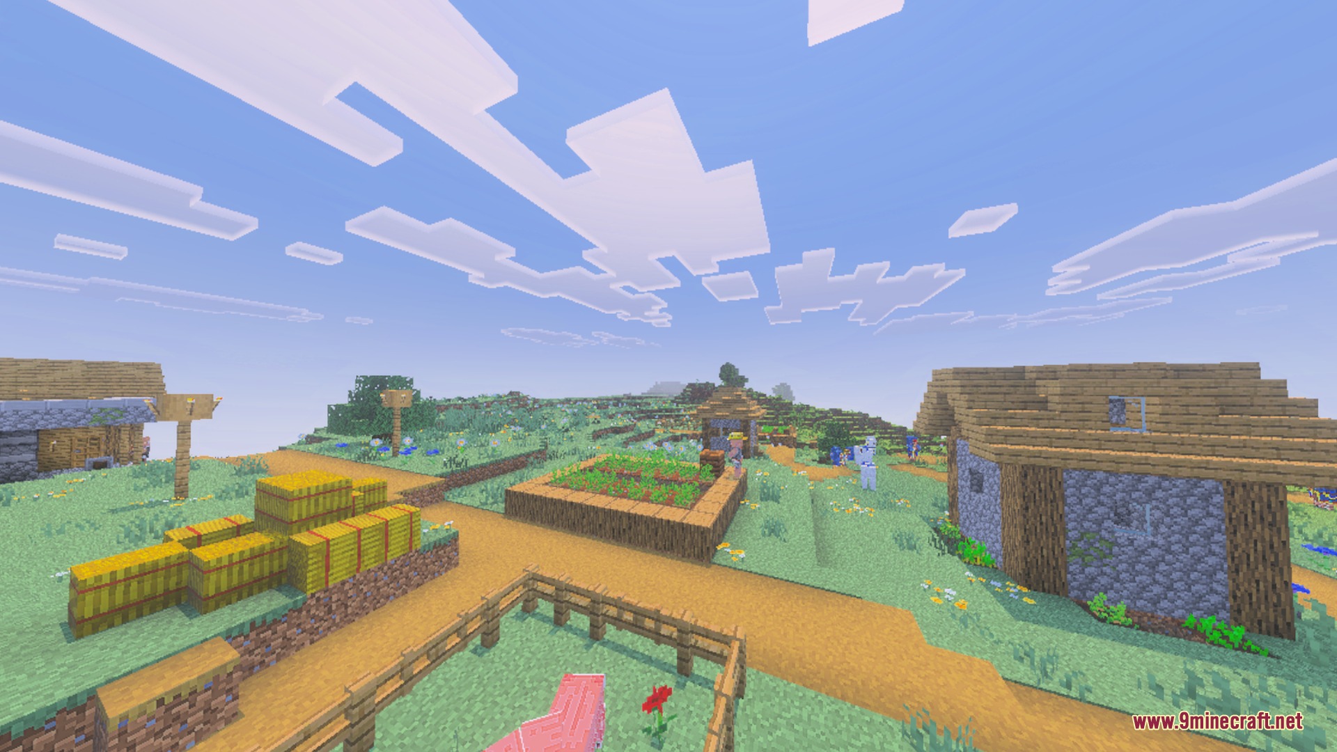 A sunny Minecraft village featuring wooden houses hay bales and a small garden