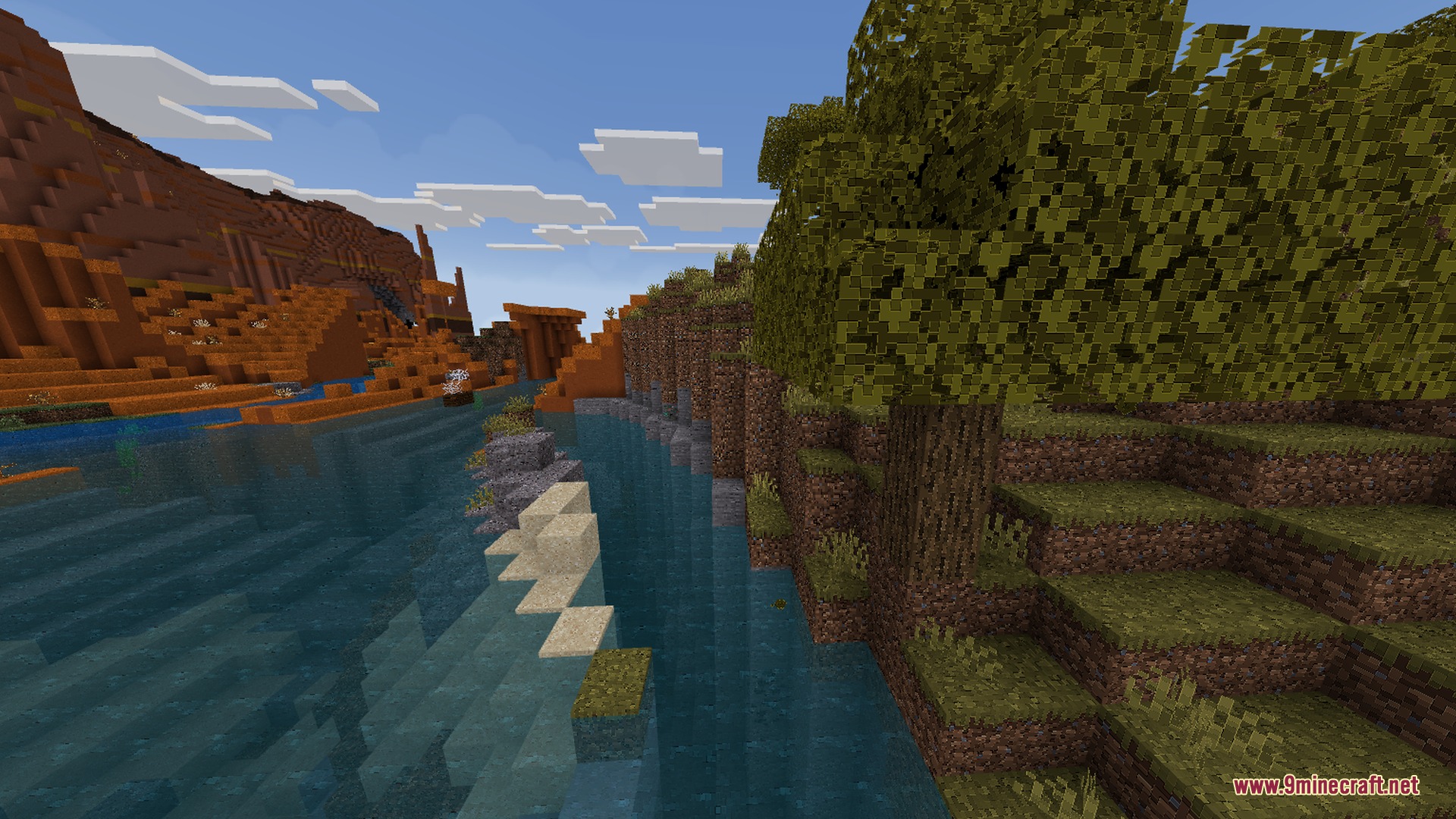 A river flowing between a mesa biome and a lush green forest