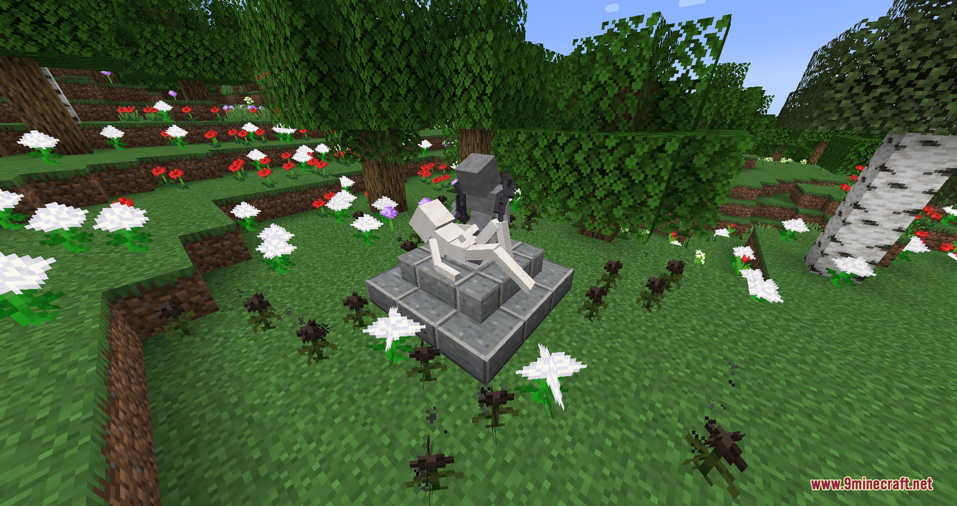 A stone altar with two white figures surrounded by flowers in a forest