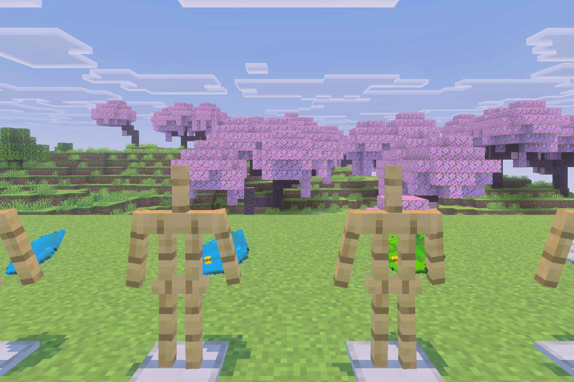 Armor stands wearing different colored backpacks in a pink cherry blossom forest