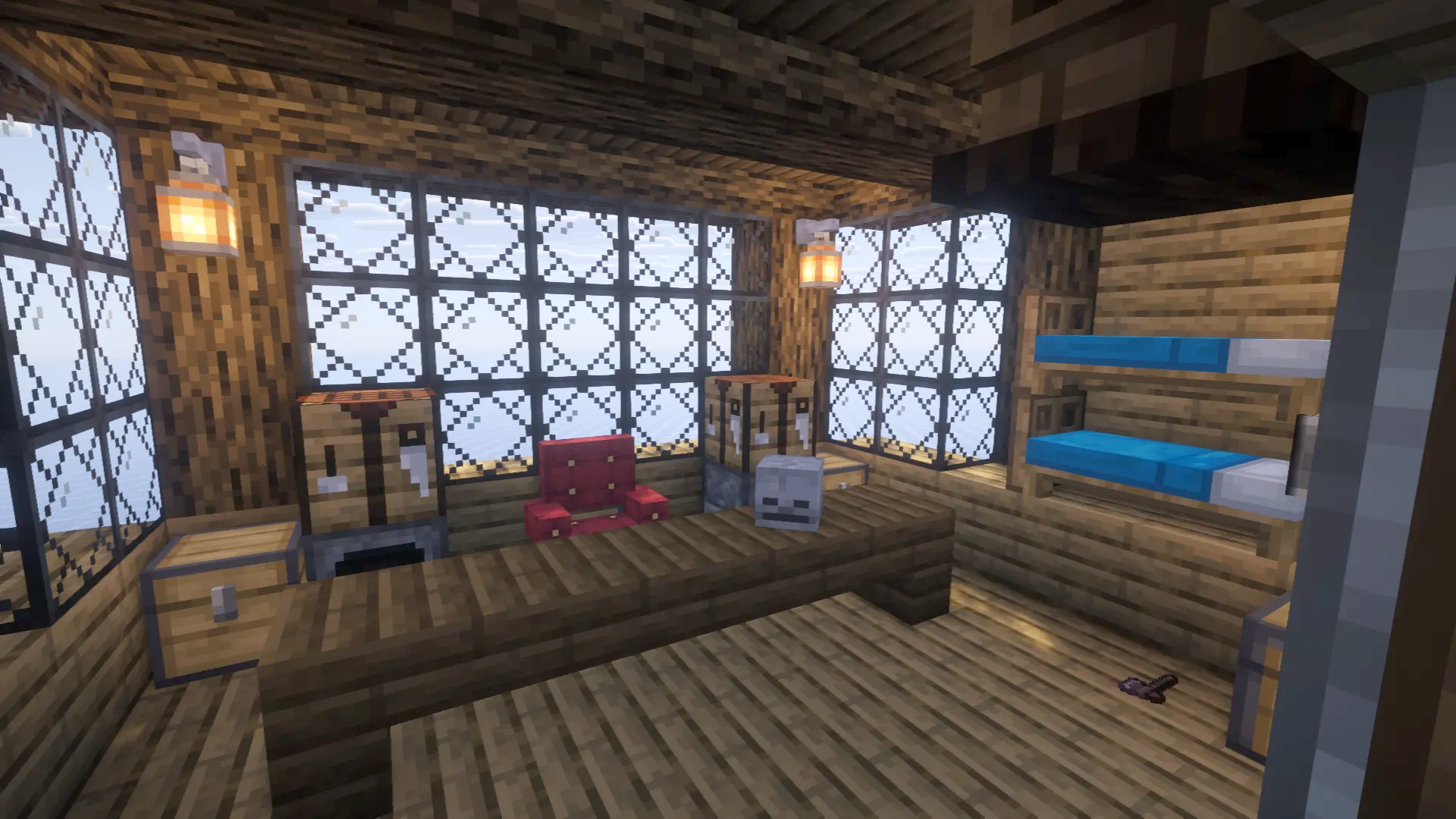 Cozy captains cabin featuring a large desk red chair and bunk beds