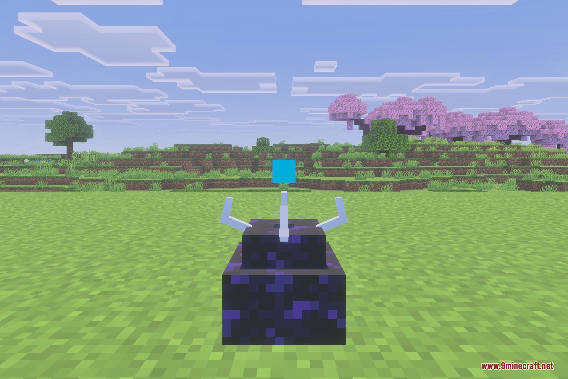 The blue chunk loading device sits on obsidian in a grassy field