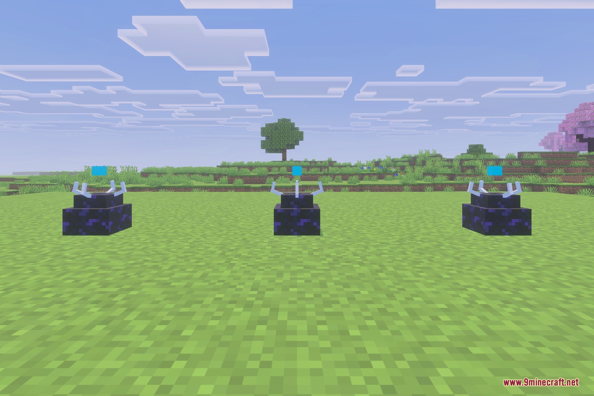 Three Simulation Core blocks placed on a grassy field under a bright sky