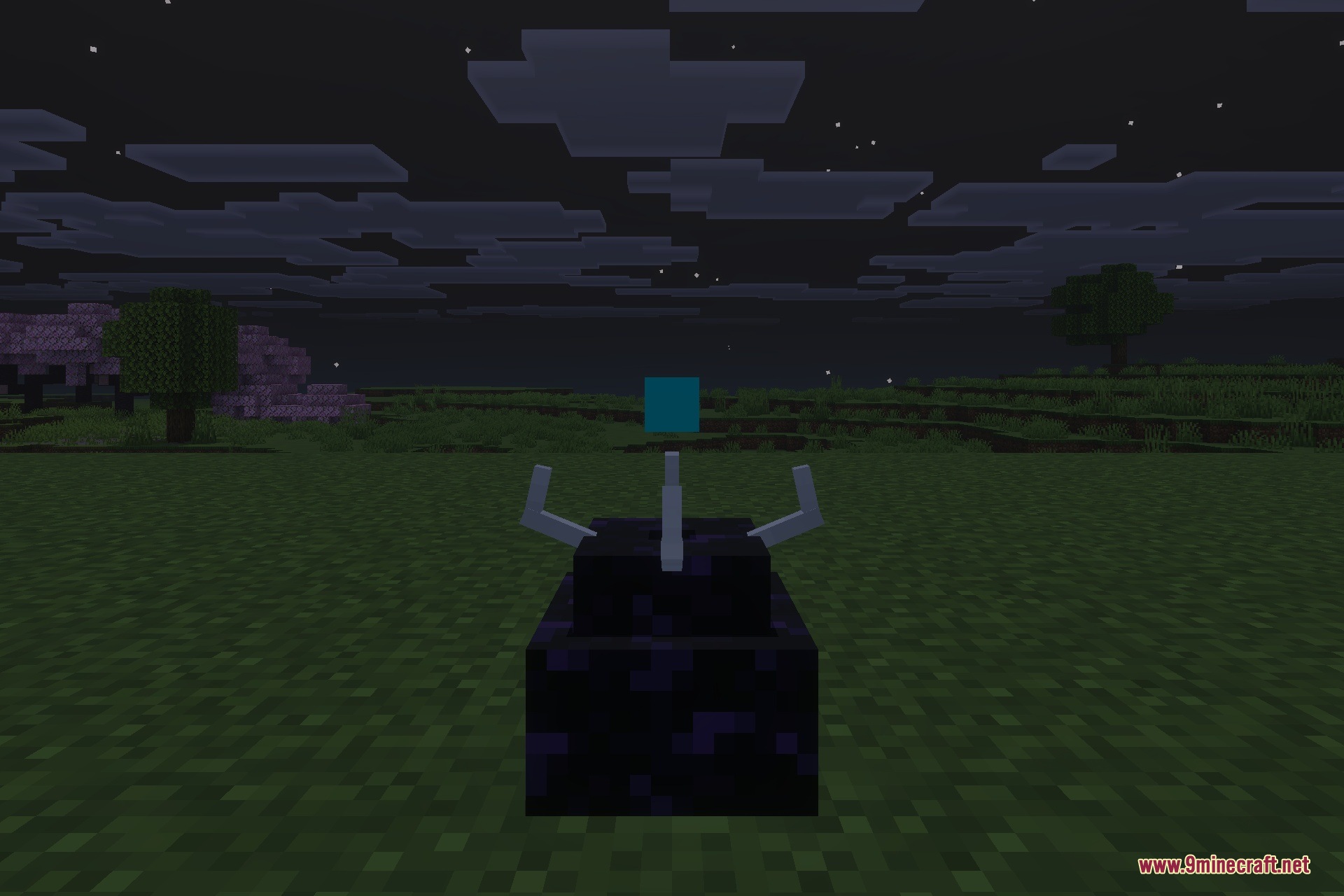 A single Simulation Core block sitting on the grass during the night