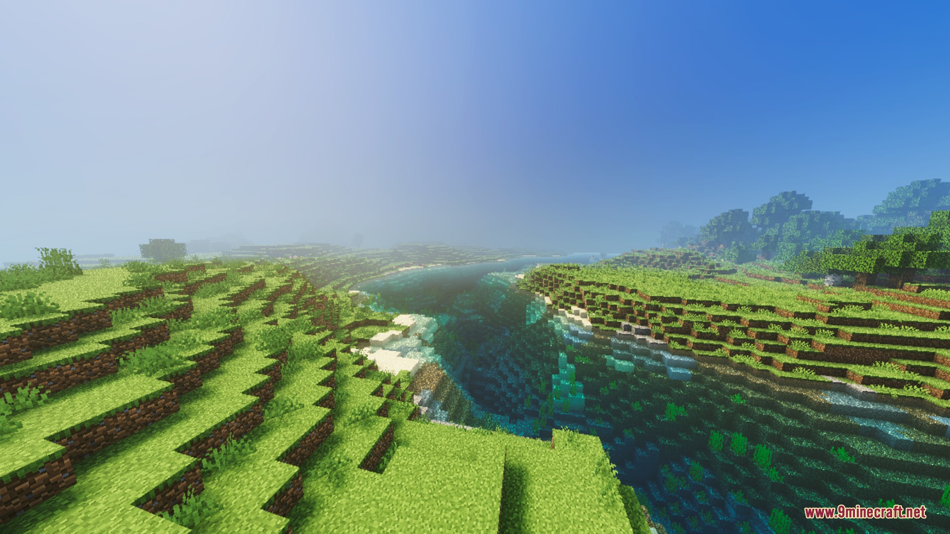 Lush green hills overlook a bright river under a warm sunlit sky