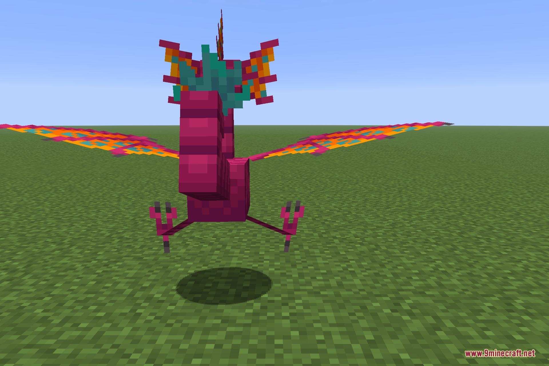 Species 9minecraft Mod Screenshot 2 A pink Wraptor creature with colorful patterned wings standing on green grass