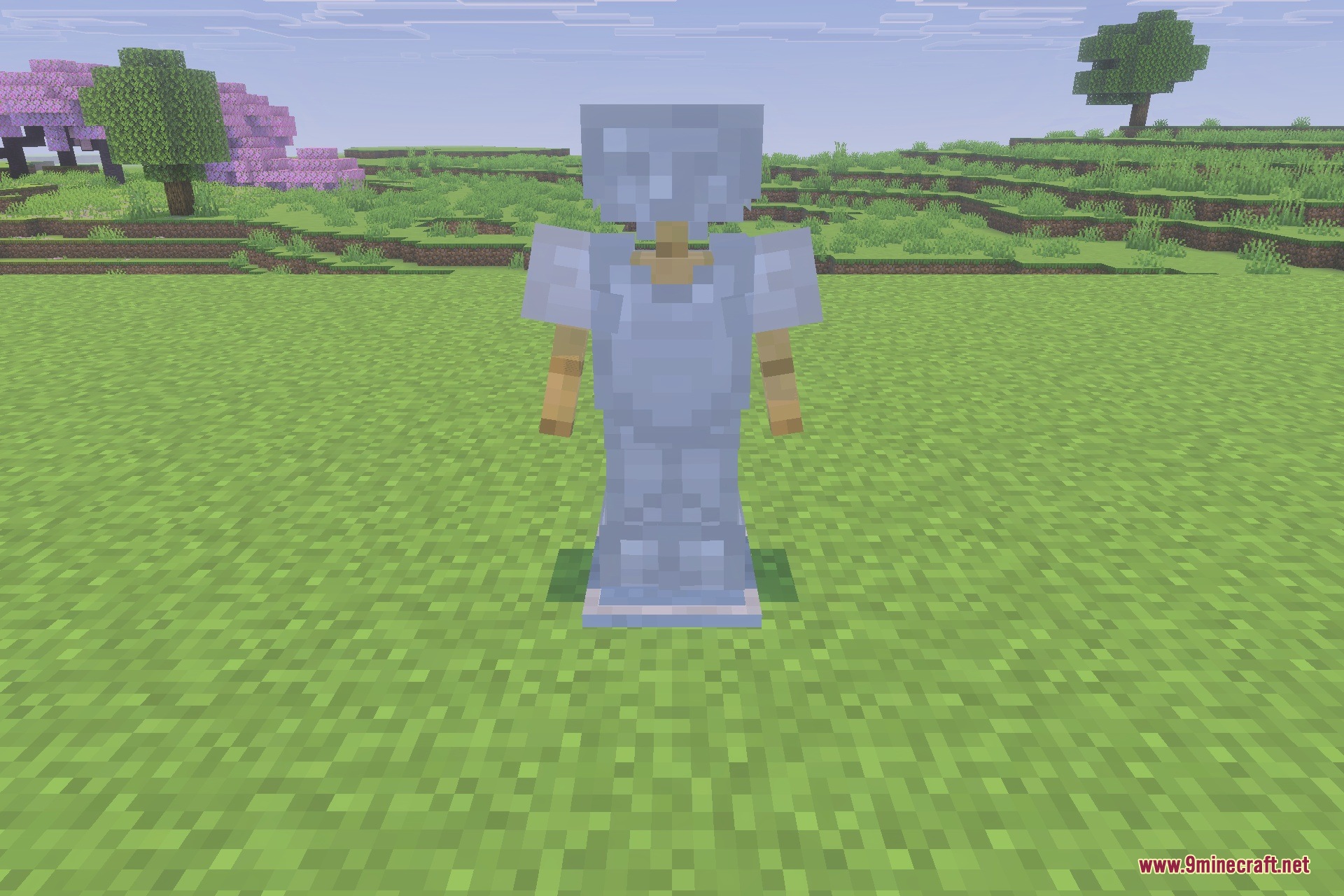 An armor stand wearing a full set of iron armor in a field
