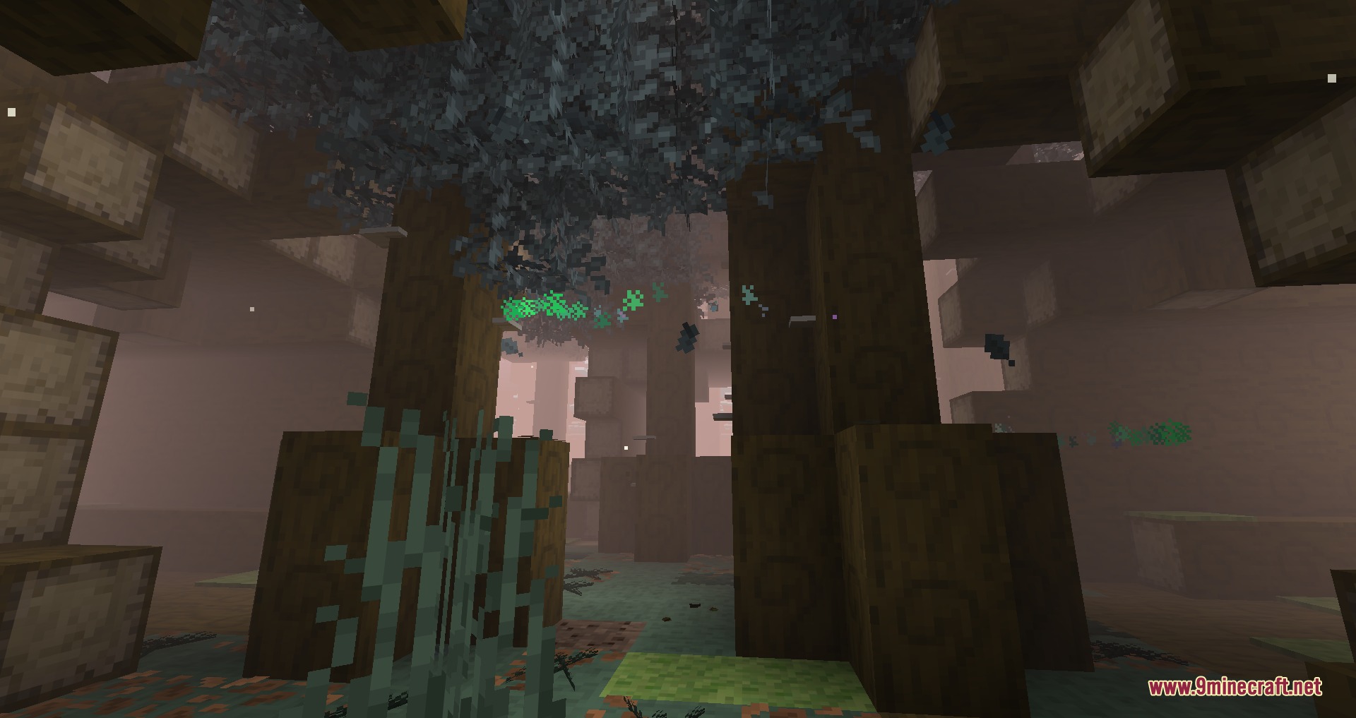 Tainted Timber Trails Mod Screenshot 5 Large dark trees with blue leaves stand in a misty Minecraft forest with particles