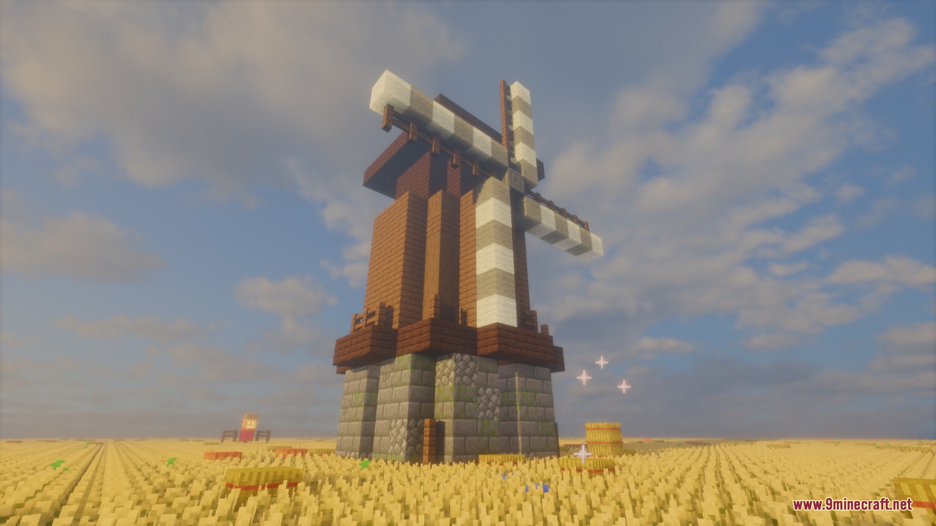 The Chronicled Rot Mod Screenshot 2 A tall windmill built with stone and wood in a large wheat field