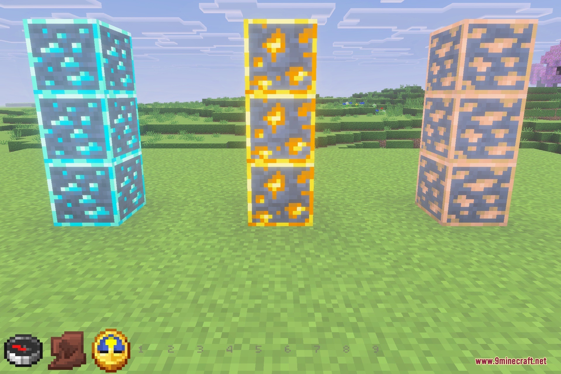 Three pillars of bordered ore blocks standing in a grassy field