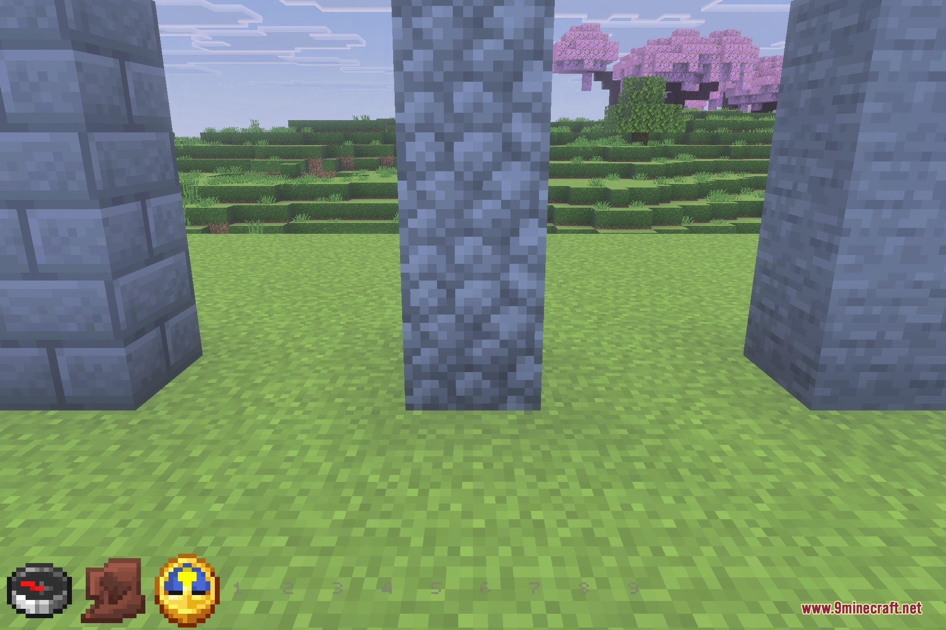 Three tall pillars of stone bricks cobblestone and stone in a field