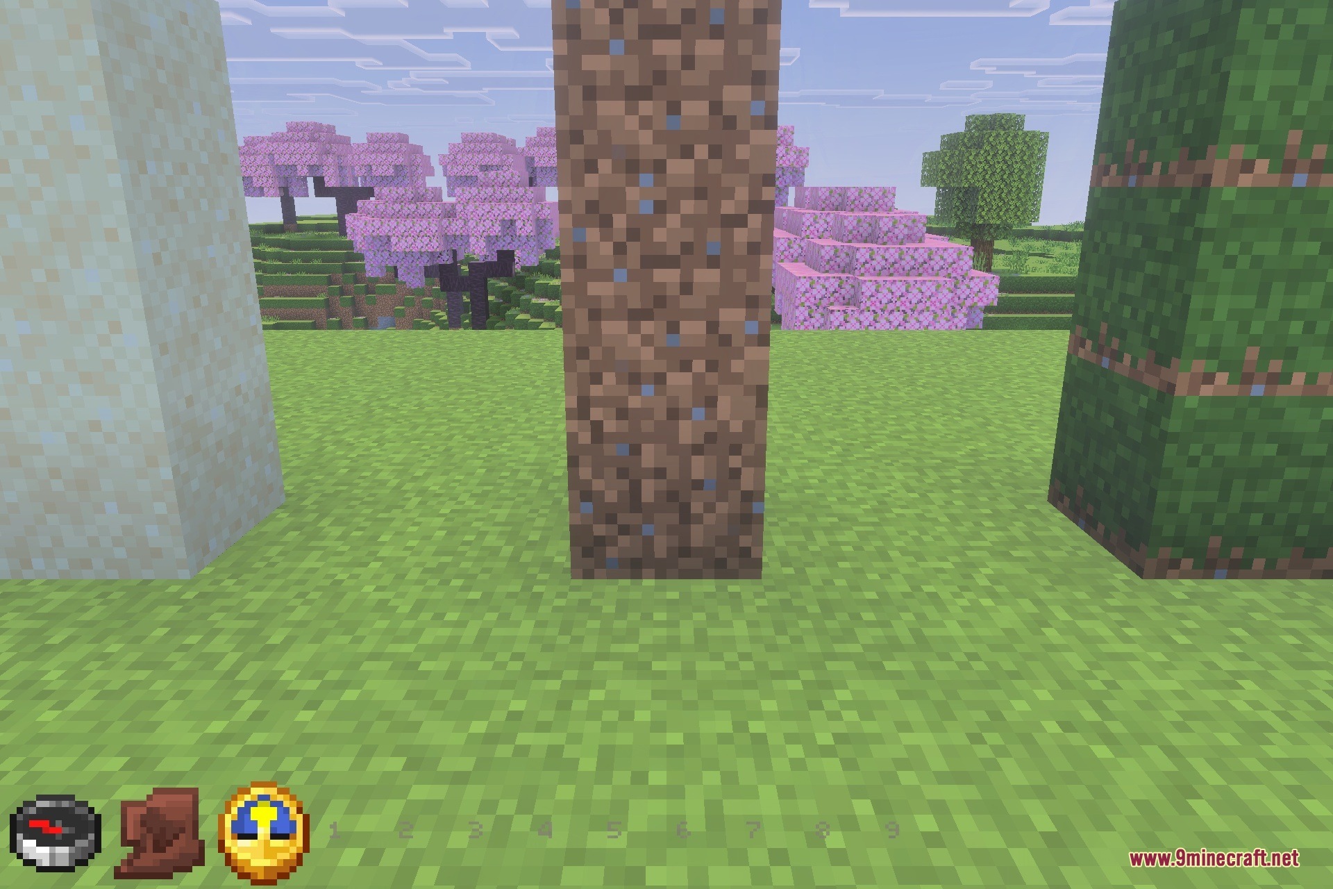 Vertical columns of sandstone dirt and grass blocks standing in a field