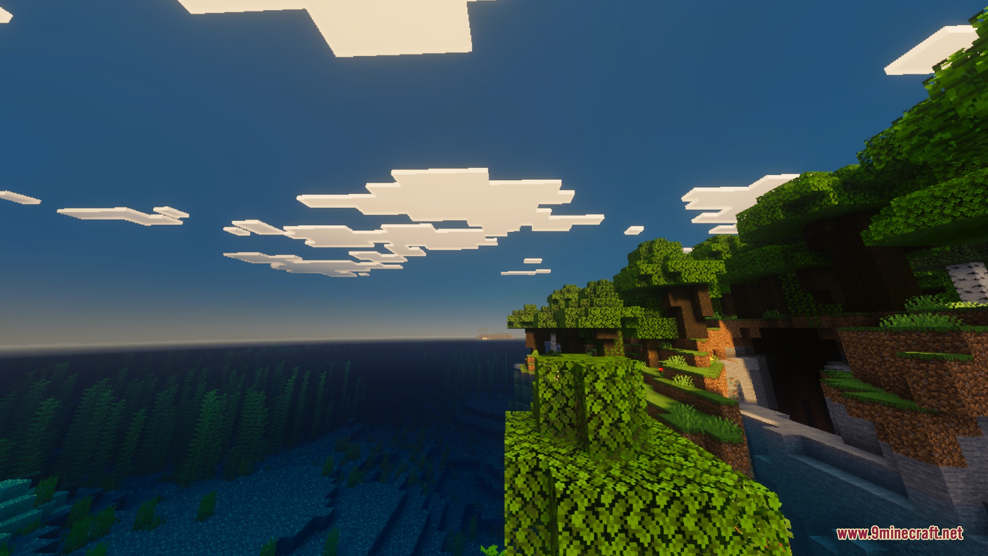 Ultimate Vibrant Visuals Shader Screenshot 2 Lush green trees on a cliff overlooking a clear ocean with blocky clouds