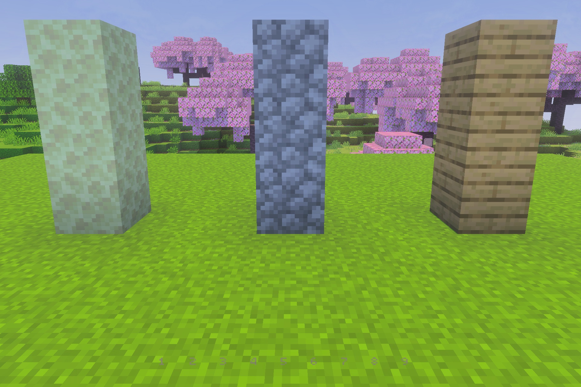 UltimatePvP Overlay Texture Pack Screenshot 1 Three vertical pillars of different blocks standing on a green grass field