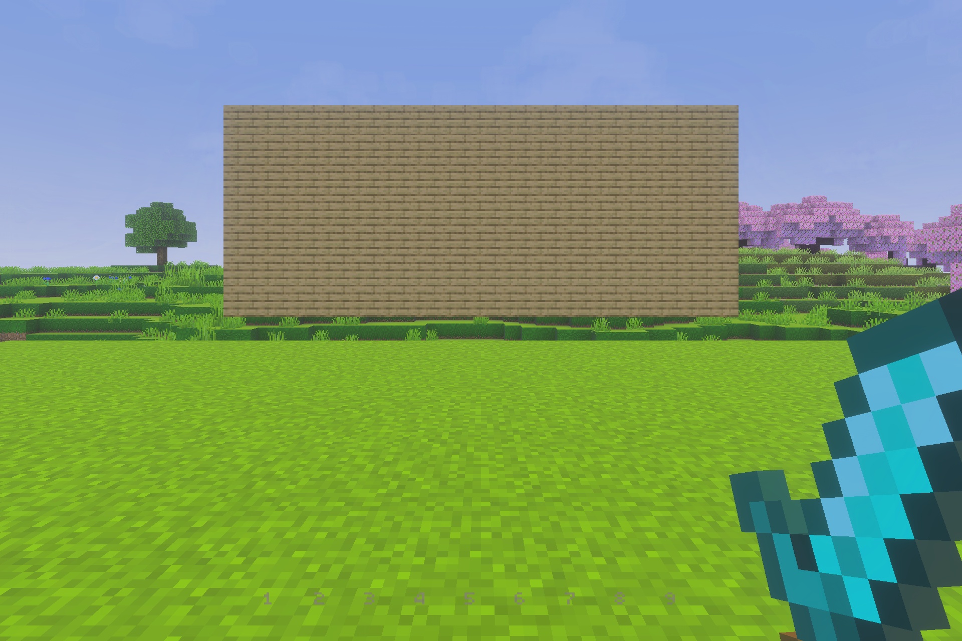 UltimatePvP Overlay Texture Pack Screenshot 2 Player holding a diamond sword in front of a large oak plank wall