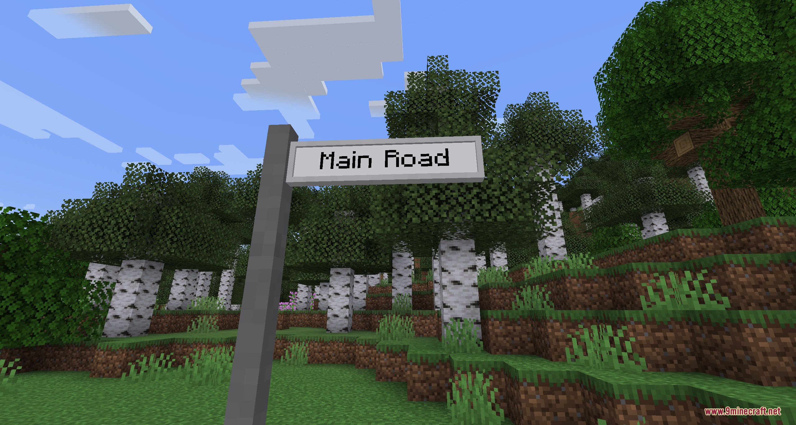 Urban Asphalt Grid Mod Screenshot 8 A writable street name sign labeled Main Road in a Minecraft birch forest
