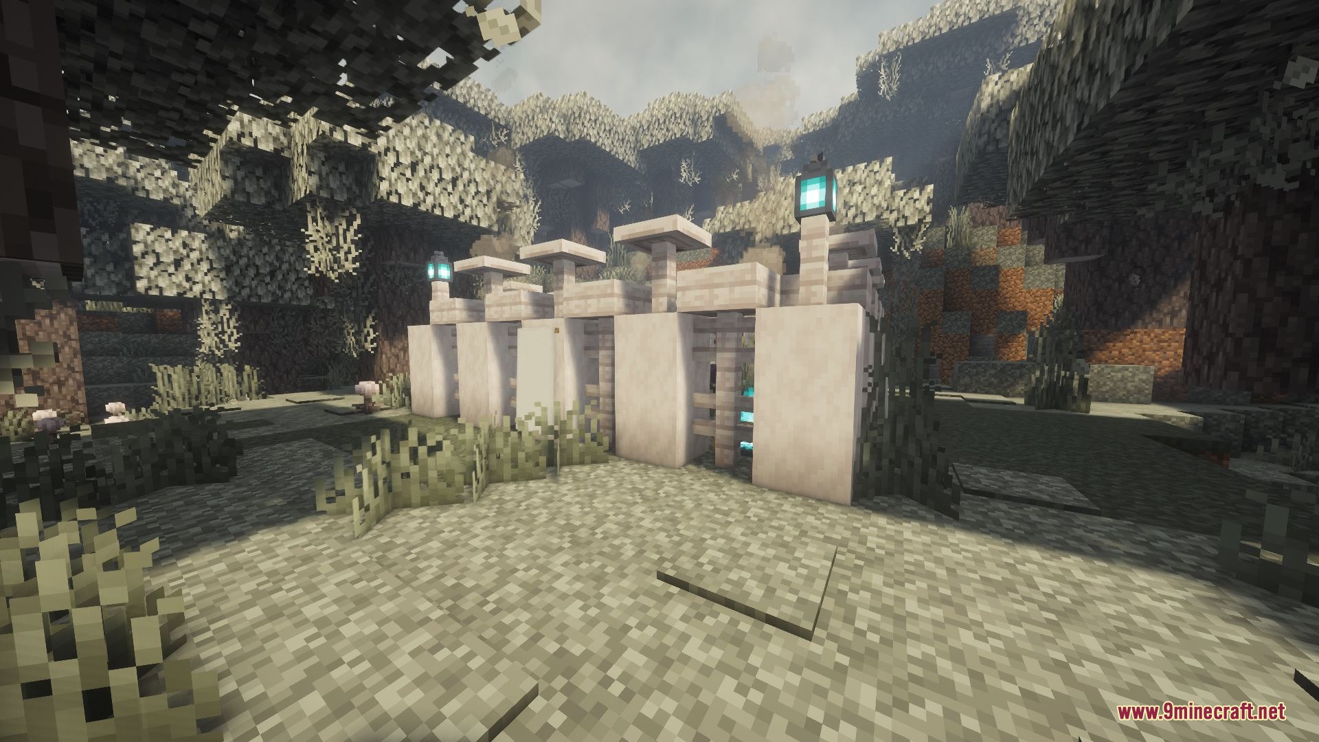 A white stone structure with lanterns stands in a rocky cave environment