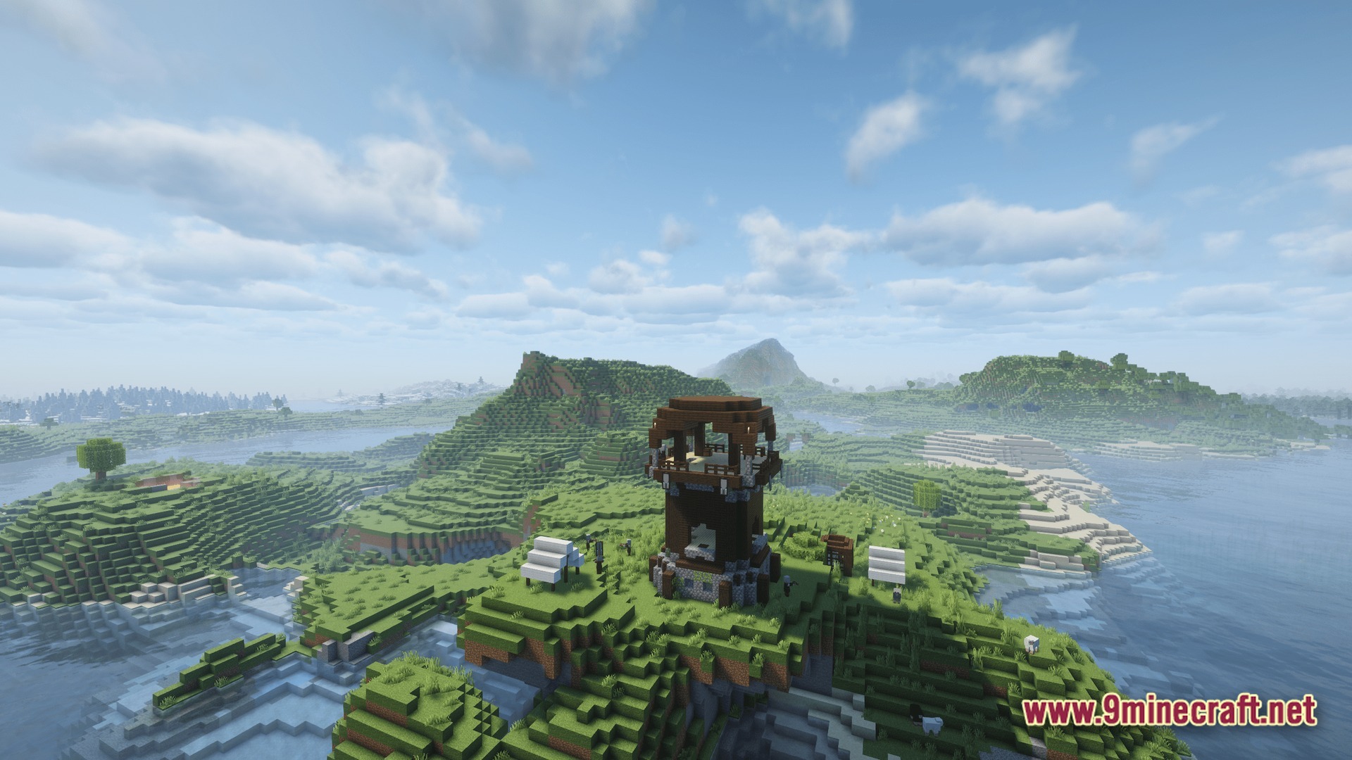 A pillager outpost stands on a grassy hill overlooking a vast river and mountain landscape