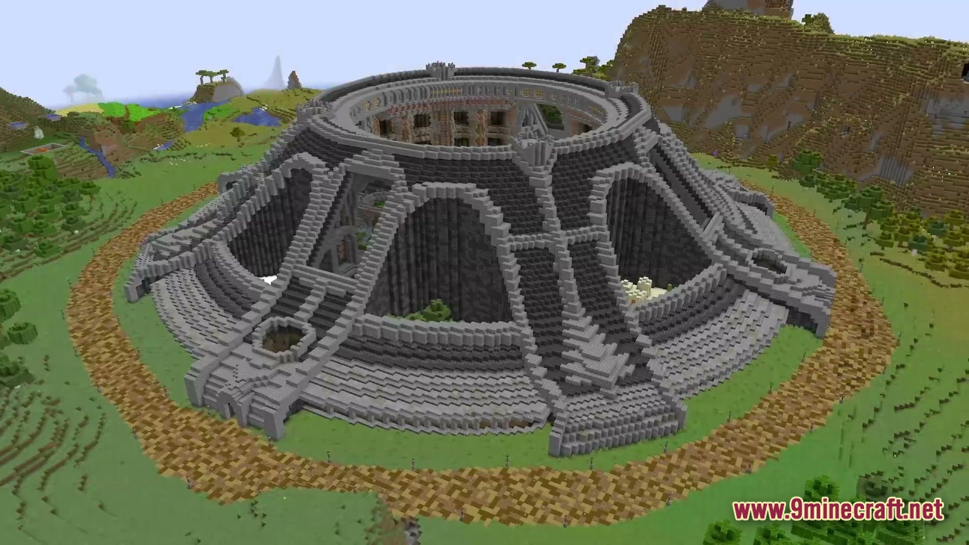 A massive circular stone arena with tiered seating and a hollow center built in a plains biome