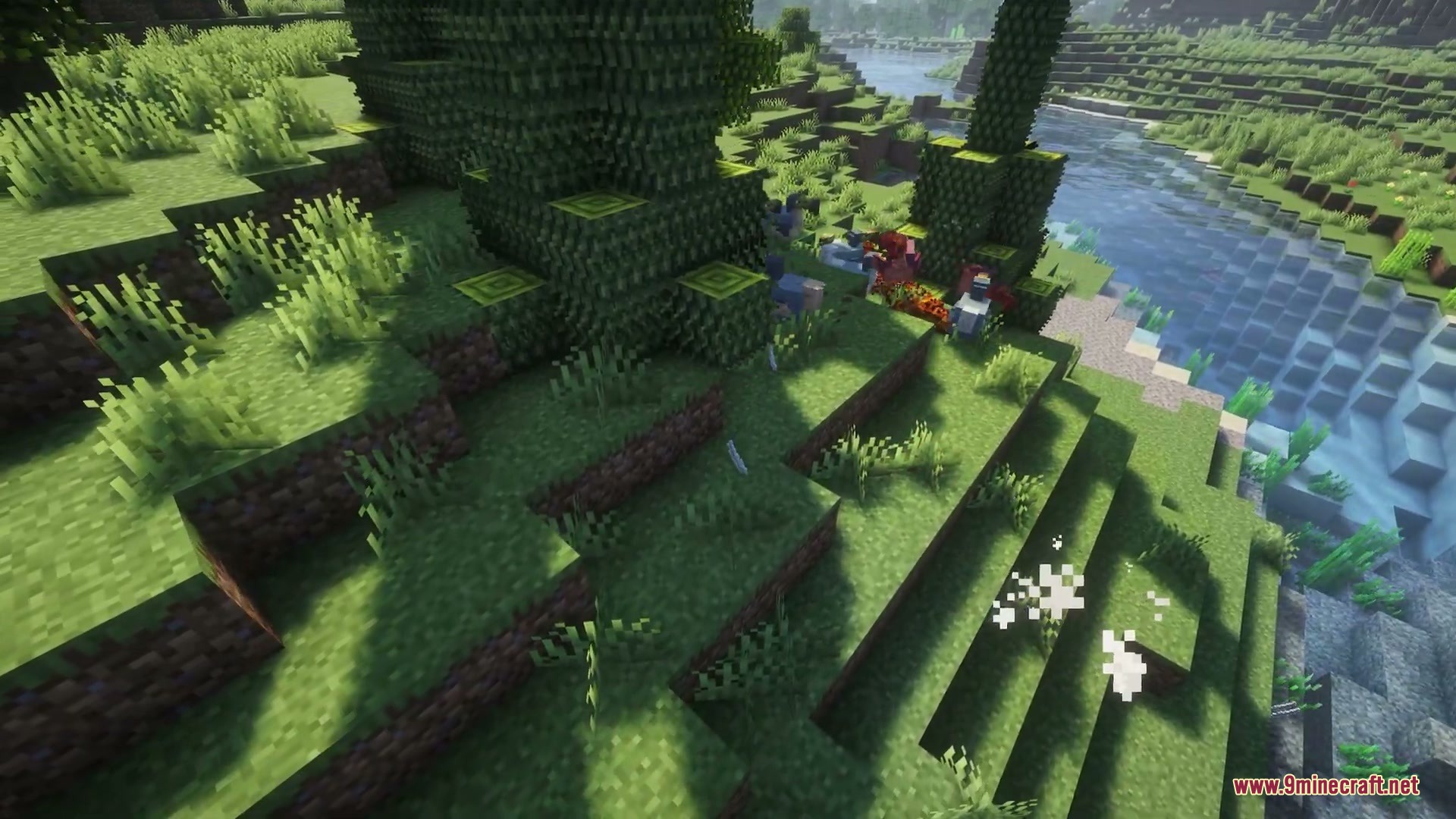 Wilderbound Frontiers Mod Screenshot 1 Prehistoric creatures resting in the grass near a riverbank in Minecraft