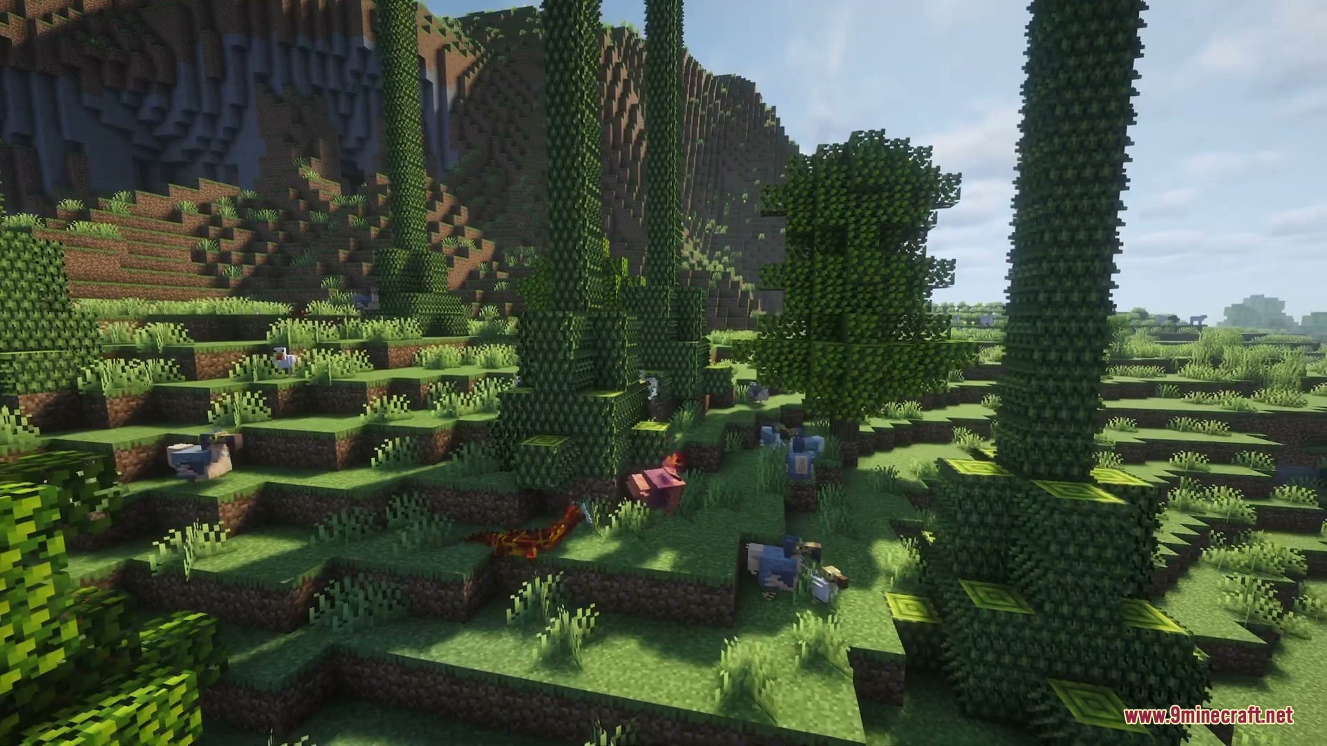 Wilderbound Frontiers Mod Screenshot 6 Small blue dinosaurs roaming a hilly landscape filled with tall leafy trees
