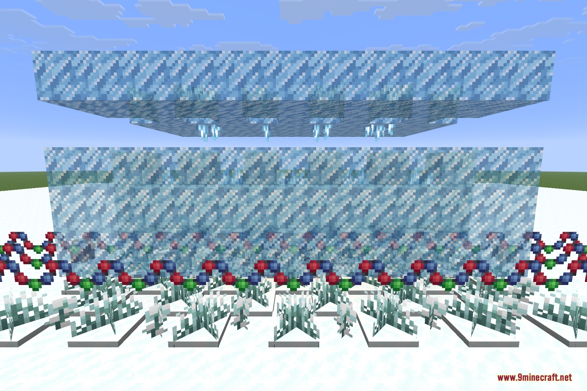 A field of frozen grass and frozen flowers around a snowguy and snowball walls