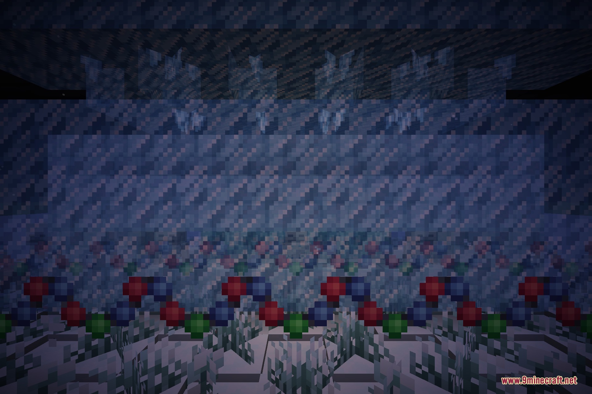 Skeletons and zombies wearing festive scarves at night beneath icicle blocks and garland lights