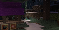 A small house with a purple roof.