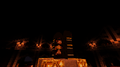A dark room lit by many lanterns.