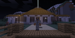 Player stands before a large building.