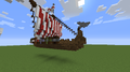 Large Viking longship with red and white sails.