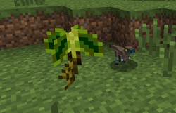 Baby Compsognathus next to a fern