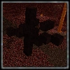 Dark, blocky cross-shaped object on ground