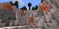 Rocky canyon with trees and orange patches